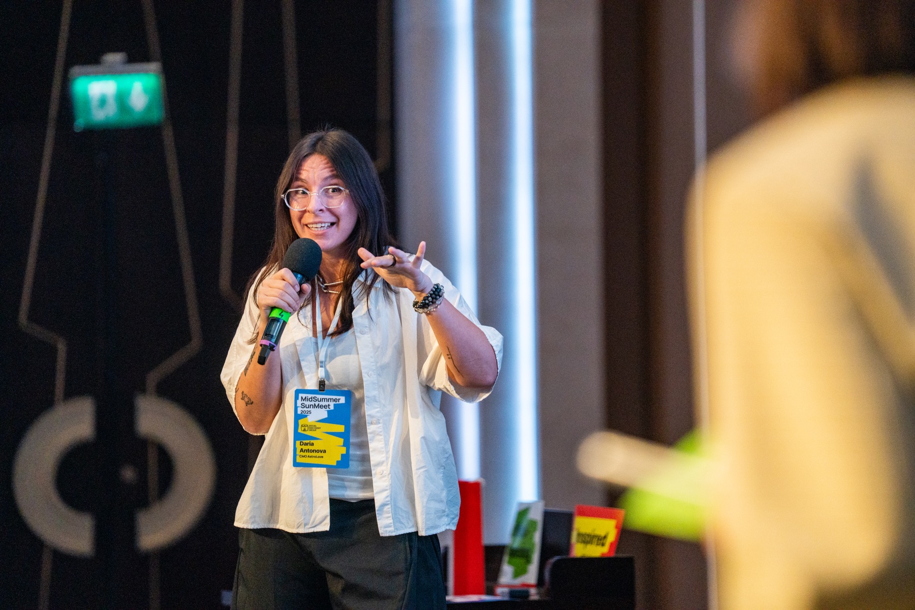 Dasha Antonova speaking with a microphone
